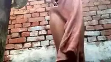 Young desi woman sets the camera on and starts her XXX shower show